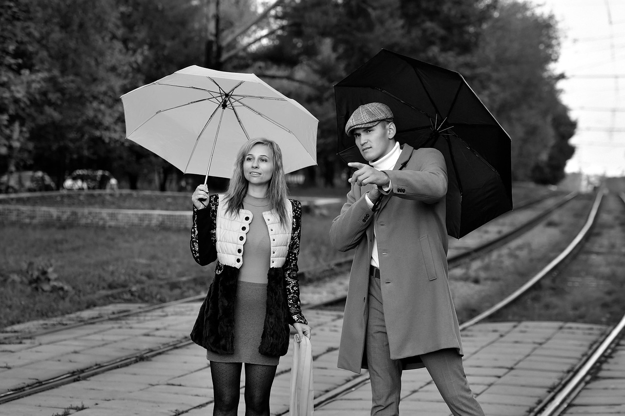 pair, lovers, street, city, railways, love story, a meeting, autumn, umbrella, together, man and woman, boy and girl, look into the distance, under the umbrella, point out, look out for, wait for the train, expectation, passengers, black and white, monochrome, bw